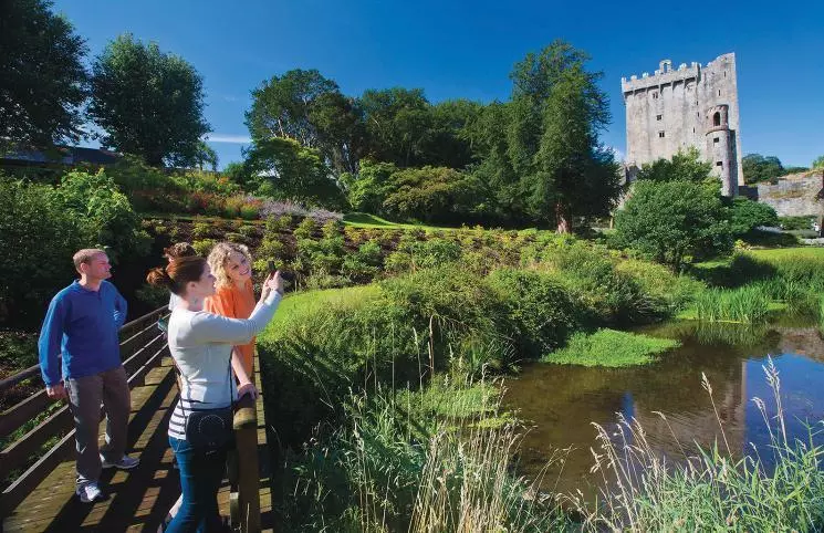 View of tourist taking pictures of Irelands plush green landscape