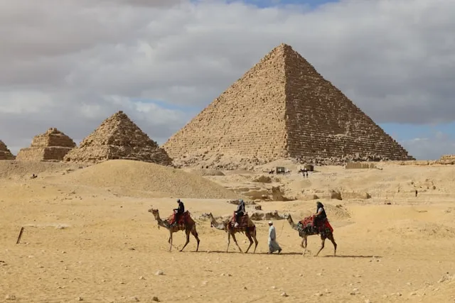 Giza pyramids with camels in the foreground