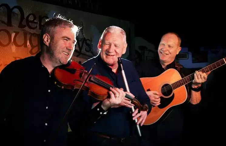 irishmen playing instruments on stage