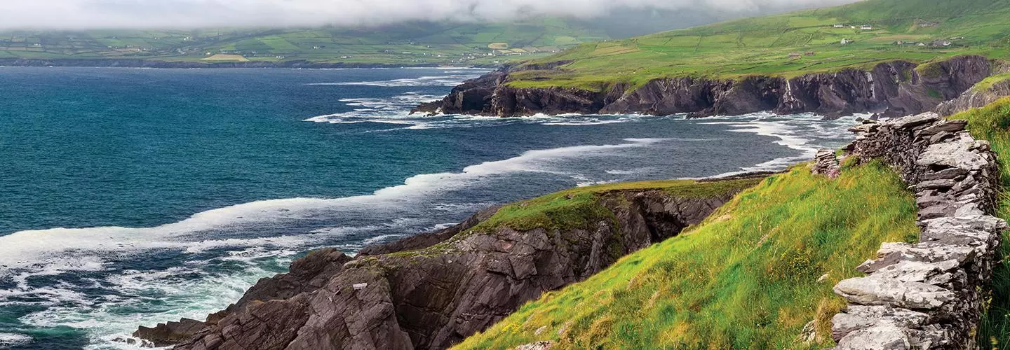 ocean waves crashing against Ireland cliffs