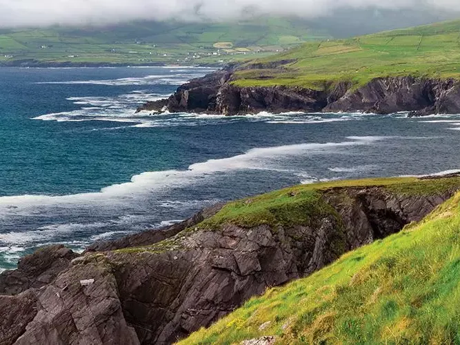 Ocean waves crashing against cliffs on the coast of Ireland